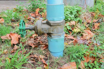 Fototapeta na wymiar Water valve Plumbing Steel on grass. industrial tap pipe