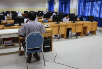 
 blurred focus teacher with student and desktop computer. 