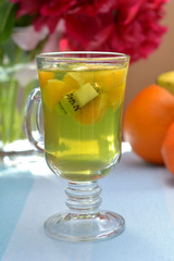 Bright kiwi jelly with pieces of orange - delicious refreshment in summer