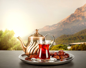 Composition for Turkish tea ceremony on table against landscape background. Culture heritage...