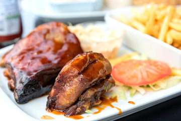 Grilled steak - Grilled meat ribs on the plate with hot sauce