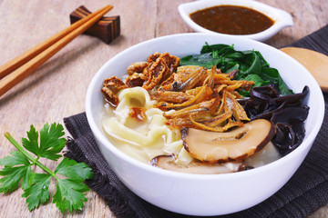 malaysian chinese cuisine pan mee noodle in soup on white bowl.