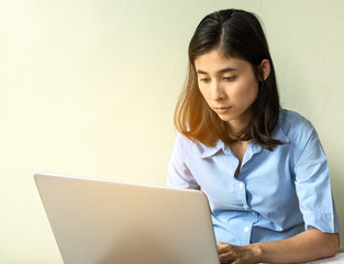 Portrait of a young business woman using laptop and think abou s