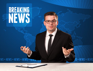 Television presenter in front telling breaking news with blue mo