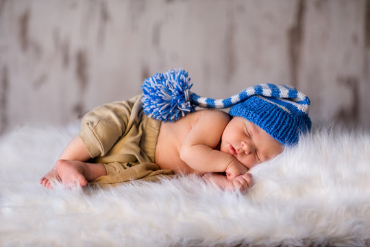 Boy kid newborn sleeping in blue hat