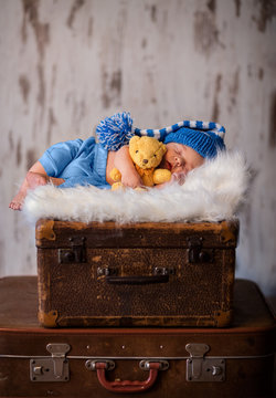 Newborn photography of 2 weeks old sleeping baby on soft fluffy