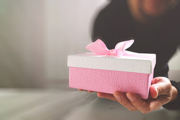 gift giving,man hand holding a gift box in a gesture of giving.b