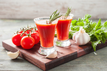 tomato juice and tomatoes on a table, selective focus