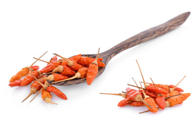 dried chilli on wooden spoon isolated on white background.