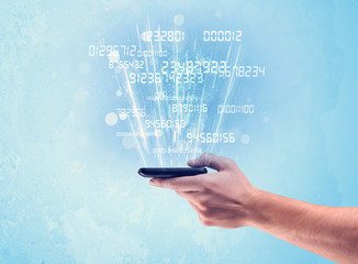 Hand holding phone with digital numbers