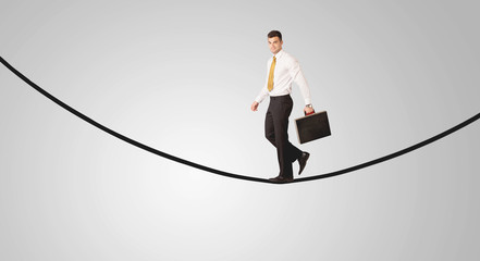 Happy businessman walking on rope