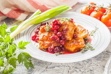 meat with cranberry sauce and vegetables on a table, selective focus