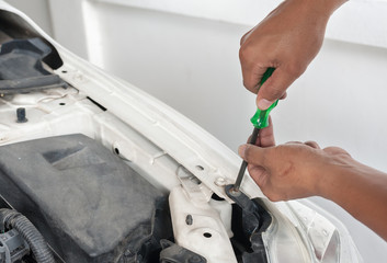 Hands of mechanic working in auto repair shop