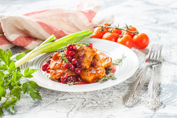 meat with cranberry sauce and vegetables on a table, selective focus
