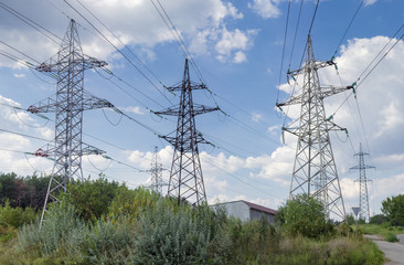 Several overhead power lines against the backdrop of a sky