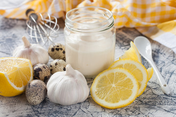 sauce in a jar and ingredients on a table, selective focus