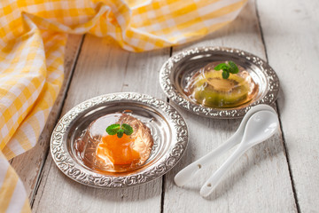 jelly with pieces of fruit on a table, selective focus