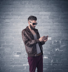 Fashion model in front of brick urban wall