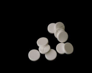 White effervescent tablets on black background