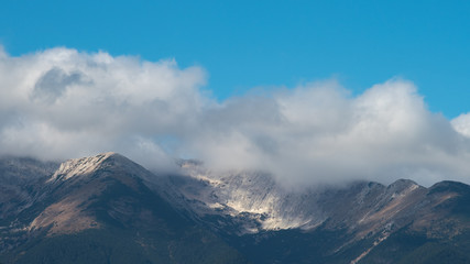 The picturesque mountain on the background of cloud stream. Wide angle