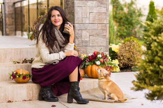 Pretty Woman Sitting On A Decorated Porch