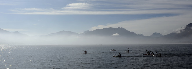 Obraz na płótnie Canvas Kayakers on kayak and canoe doing the race on Annecy lake