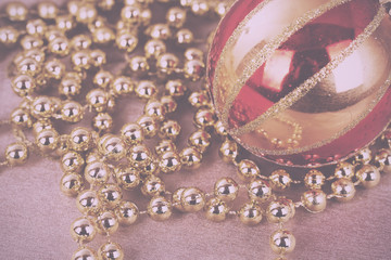 Festive gold Christmas decorations on fabric background Vintage