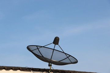 Black  satellite install on the roof, blue sky background