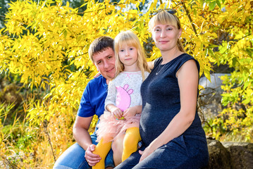 Happy family portrait outdoors in autumn