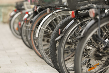 Fototapeta na wymiar multiple bicycles standing in stand in munich, low focus
