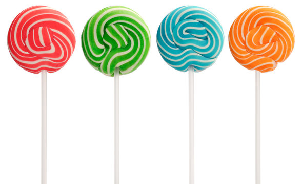 Red, green, blue and orange mini lollipops isolated on white. White swirls and white sticks.