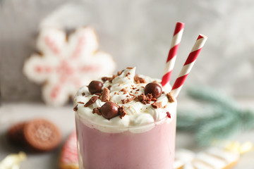 Delicious milkshake with Christmas decoration on grey textured background