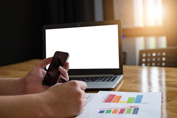 Businessman at work. Holding pencil in his hand. Architectural project on table