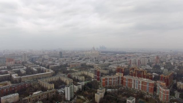Flying over Russia capital. Panorama with many apartments blocks. State University and Moscow City Business Centre in the distance