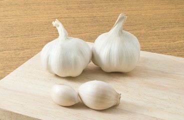 Garlic Bulbs and Garlic Cloves on Cutting Board