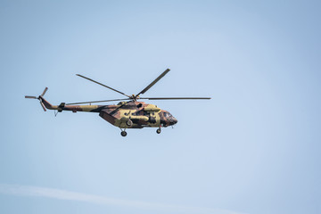 Fototapeta na wymiar Military helicopter on blue sky background