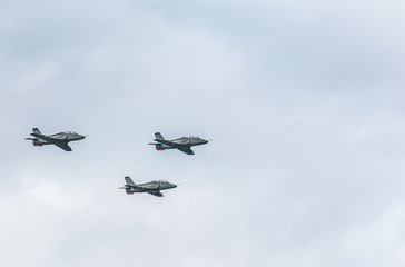Fototapeta na wymiar Fihter jets on cloudy sky background