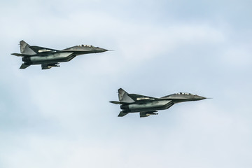 Two fighter jets mig-29  on blue sky background
