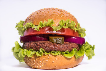 Big burger with beef cutlet and fresh vegetables isolated on white backgound
