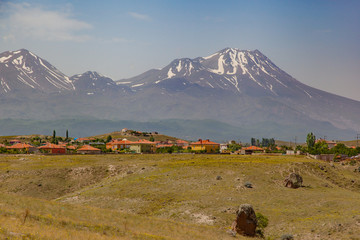 Small village and snowy volcano behind