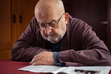 pensioner reading newspaper