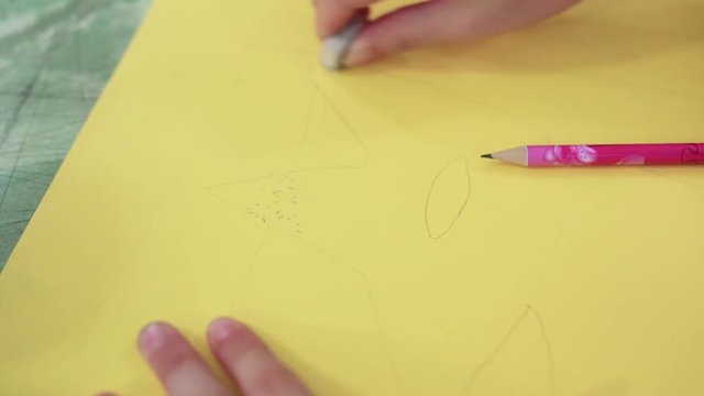 The girl draws a picture paints in classroom