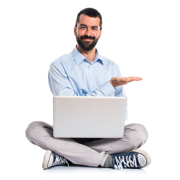 Man With Laptop Presenting Something