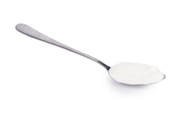 Sour cream in a spoon. On white, isolated background.
