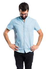 Fototapeta premium Handsome man with blue glasses looking down