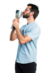 Handsome man with blue glasses holding a trophy