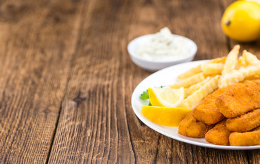 Fisch Sticks (close-up shot) on an old wooden table