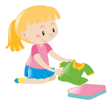Little girl in pink folding clothes
