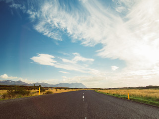 Fototapeta premium Empty road with a blue cloudy sky, Iceland