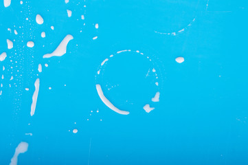 Trace on the glass of milk. on a blue background.Top view. Flat lay.